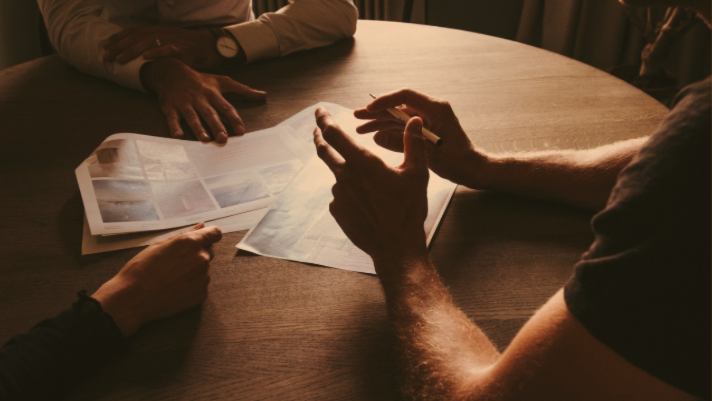 financial professional speaking to clients at table