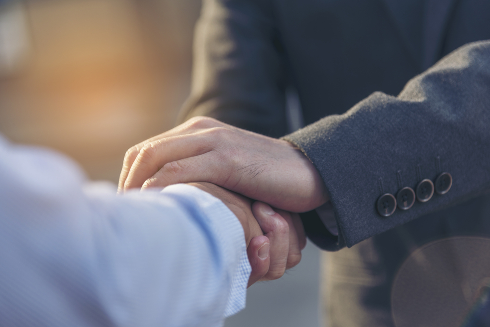 man's hands consoling in trustworthy fashion