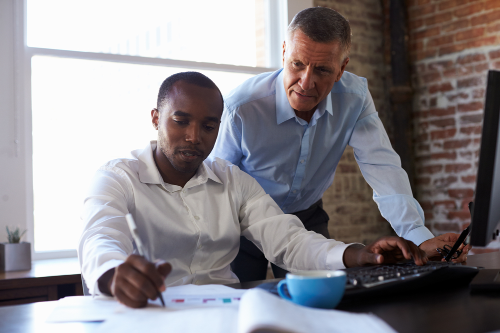 Financial professional mentoring younger financial professional for succession planning